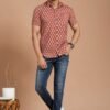 Man wearing red floral print cotton short-sleeve shirt with blue jeans