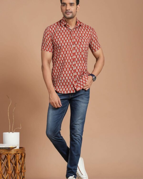 Man wearing red floral print cotton short-sleeve shirt with blue jeans
