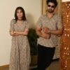 Couple wearing matching beige cotton dress and shirt with swirl block print