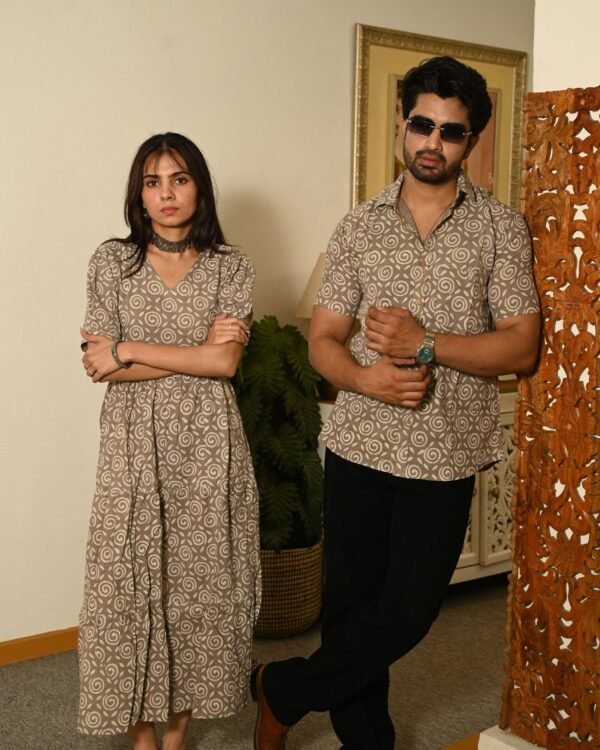 Couple wearing matching beige cotton dress and shirt with swirl block print