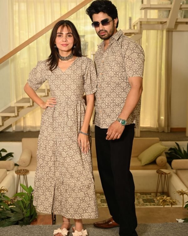 Couple wearing matching beige cotton dress and shirt with swirl block print