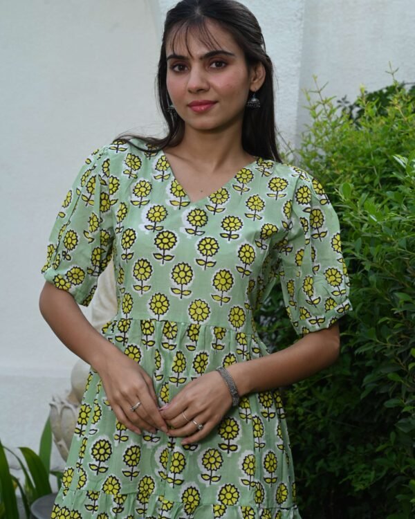 Woman wearing light green floral printed cotton Anarkali maxi dress with puff sleeves