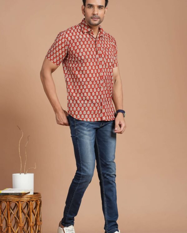 Man wearing red floral print cotton short-sleeve shirt with blue jeans